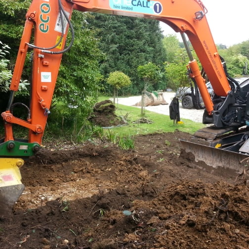 Excavator next to house