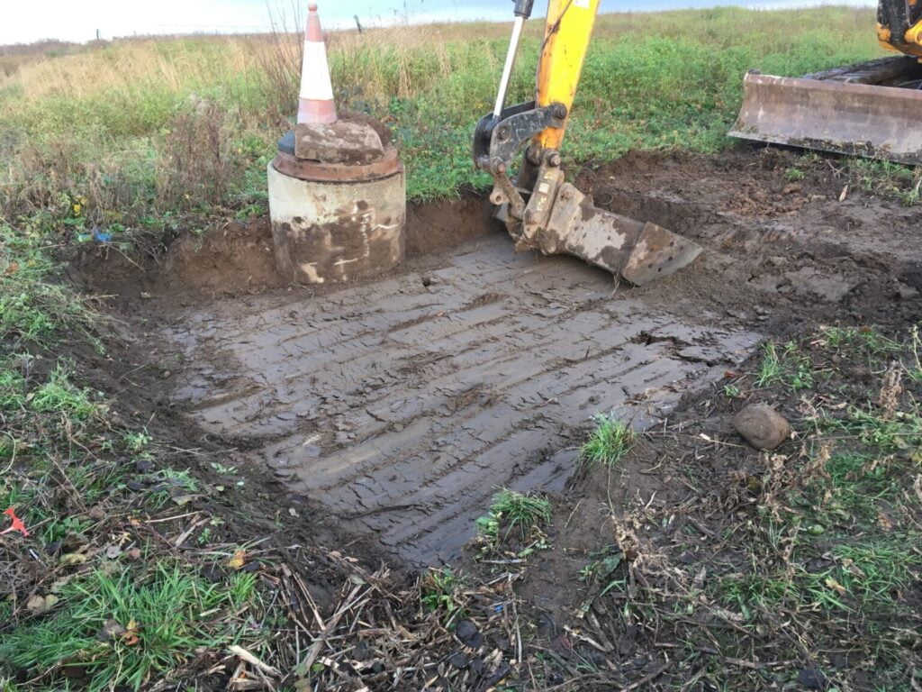 Machine excavating invasive plant on a site in Bridgend