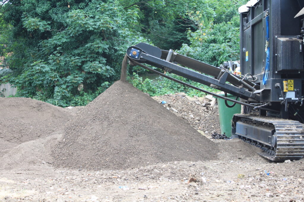 Clean soil being filtered from Japanese knotweed rhizome by Japanese knotweed excavator