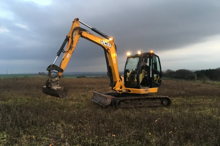 Digger being operated on land due to be developed