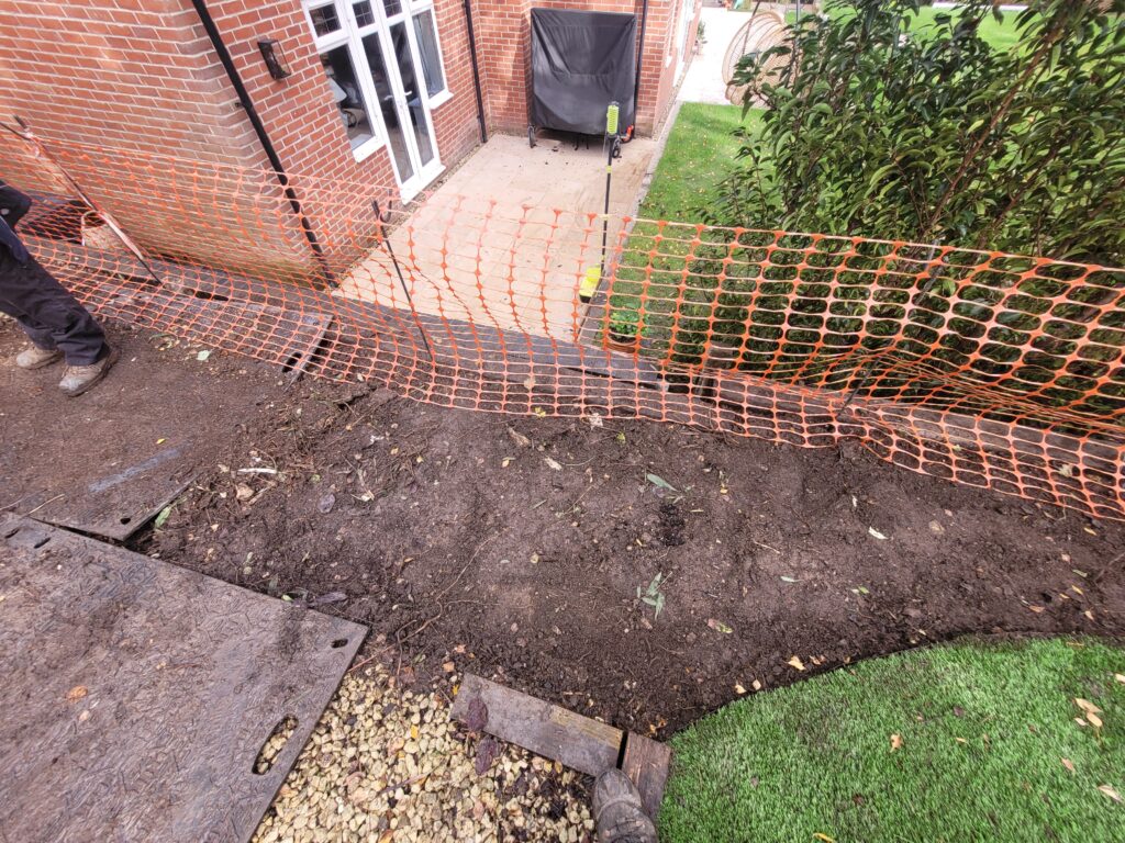Root barrier being built in a garden